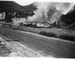 American hostels at the base burn during the American and Chinese retreat before the Japanese arrive during the Ichigo push in the fall of 1944.  Guangxi province, Liuzhou air base.