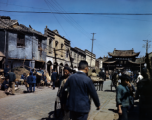 Street and markets near "Emerald Chicken" 碧鸡 and "Golden Horse" 金马 gates in Kunming during WWII, usually considered a pair: Golden Horse And Emerald Rooster Archway (金马碧鸡坊).  In the CBI during WWII.