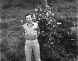 Eugene Wozniak poses among pines at Yangkai air base during WWII.