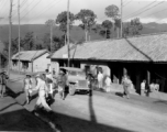 Offices and hostel area at Yangkai air base during WWII. Sign says, "Drive SLOW--Dust".