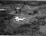 Aerial view of tidy structures on the ground in Burma or French Indochina, in the CBI, during WWII.