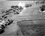 Bombing of small rail bridge, among a flood plain, in French Indochina during WWII.