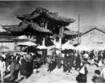 Local people in Yunnan province, China, during WWII: People come and go through gate.