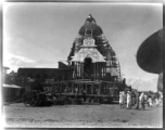 Enormous floats for a religious parade being assembled. Probably for the the Rath Yatra celebration at the large Jagannath Temple of Odisha complex (Hindu) in India.  Scenes in India witnessed by American GIs during WWII. For many Americans of that era, with their limited experience traveling, the everyday sights and sounds overseas were new, intriguing, and photo worthy.