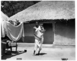 Woman holding child.  Scenes in India witnessed by American GIs during WWII. For many Americans of that era, with their limited experience traveling, the everyday sights and sounds overseas were new, intriguing, and photo worthy.