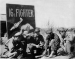 American flyers of the 16th Fighter Squadron in China, before a sign at Chenggong. Stanley Mamlock in center of group.  In Chinese the sign says "Great Wall In The Air" ("空中長城").  During WWII.