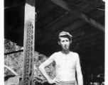 Engineer of the 797th Engineer Forestry Company poses with sharp chain from chainsaw in Burma.  During WWII.