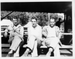 Engineers of the 797th Engineer Forestry Company pose a plank mess tables at a camp in Burma.  During WWII.