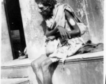 Man begs on road in town in Burma or India.  Near the 797th Engineer Forestry Company.  During WWII.