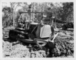 Bulldozer pushing dirt in Burma.  797th Engineer Forestry Company in Burma.  During WWII.