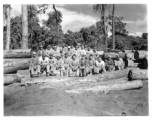 Engineers of the 797th Engineer Forestry Company pose on logs in Burma.  During WWII.