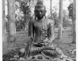 Bronze Buddha inside remains of Buddhist temple in Burma.  During WWII.