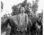 Local people in Burma near the 797th Engineer Forestry Company--A man poses with horse.  During WWII.