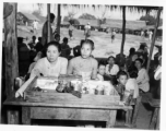 Ladies vending cigars, cigarettes, white face powder, etc., at an activity in Burma.  In Burma near the 797th Engineer Forestry Company.  During WWII.