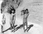 Men carry firewood on road in Burma.  Near the 797th Engineer Forestry Company.  During WWII.