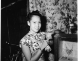 Local people in Burma near the 797th Engineer Forestry Company--a merchant girl in a fine shop in Burma. Given her clothing and economic niche, she is likely to be a member in a Chinese merchant family.  During WWII.
