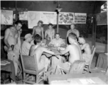 Engineers of the 797th Engineer Forestry Company playing cards at camp in Burma.  During WWII.