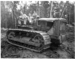 GIs pose on bulldozer in Burma.  797th Engineer Forestry Company in Burma.  During WWII.