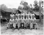 Engineers of the 797th Engineer Forestry Company pose outside tents with basketball gear in Burma.  During WWII.