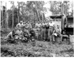 Engineers of the 797th Engineer Forestry Company pose at work site eating sandwiches, in Burma.  During WWII.