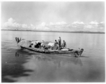 People pole a boat in Burma.  Local people in Burma near the 797th Engineer Forestry Company.  During WWII.