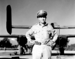 An American flyer in the CBI standing by the tail of a B-25 in the CBI.