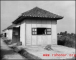 Several small buildings on a base in China during WWII.