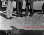 Chennault and Chinese officers pose and chat next to a B-25 Mitchell bomber in China during WWII.