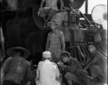 Chinese refugees take a meal in front of the train engine in Liuzhou during WWII, in the fall of 1944, as the Japanese advanced during the Ichigo campaign.