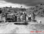 Getting a few last vehicles across a bridge at Liuzhou before the Japanese advance in the fall of 1944. The bridge decking planks have been removed, but there are enough free planks that by moving a few planks, then moving forward a bit on those planks, then moving a few more planks, the jeep can creep across.