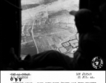 Homeward bound...through open door (which has been removed to facilitate unloading cargo on air dropping mission over front lines) crew look on mountainous terrain and rice paddies enroute to base at Yunnanyi, China.  Photo by T/4 Clayton, 21 June 1944