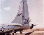 A B-29 bomber, tail number 26340, under maintenance, with a Chinese soldier standing guard, in the CBI.