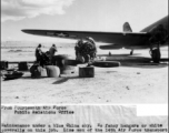 Maintenance under a blue China sky. No fancy hangers or white coveralls for this job. Line men from the 14th Air Force transport unit pull an overhaul under the wing of a C-47.