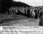 Colonel Norman McNeill, Inf., American commandant and senior instructor of the Chinese General Staff School introduces a B-24 bomber pilot of Maj. Gen. Claire Chennaults 14th Air Force to Chinese officers attending the school at a 14th Air Force base...