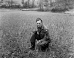 An American soldier in the CBI kneeling in a fallow rice paddy in China during WWII.