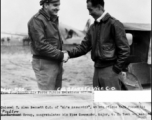 Colonel T. Alan Bennett CO of "Al's Assassins", as his pilots have dubbed his fighter group, congratulates his Vice Commander, Major C. H. Yuan who escaped from the Japanese. 