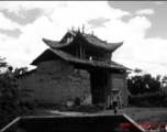 An adobe brick building in countryside in China during WWII, probably in Yunnan province.