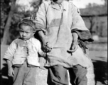 Local people in China, probably in Yunnan province during WWII: An elderly woman and child.