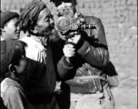 A photographer lets an old man try out his movie camera in the CBI.