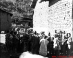 An American photographer interacts with local people in a village in Yunnan during WWII.