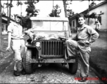 American GIs in China during WWII, with a carbine and the small animal they have hunted on their jeep.