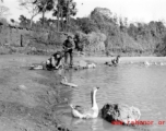 Local people in a village near Yangkai, Yunnan province, China, was items in a pond. During WWII.