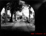 Looking at a bridge through a city gate onto a small bridge over a canal, in Yunnan province, China. During WWII.