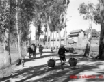 Local people walking near a village in Yunnan province, China. During WWII.