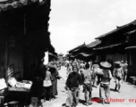 Local people in Yunnan province, China: A town street with drum tower (or bell tower) at the center. During WWII.