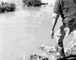 A women washes clothes near Yangkai, Yunnan province, China, during WWII.