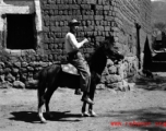 Local people in China: A man in rural China rides a donkey during WWII.  From the collection of Eugene T. Wozniak.