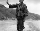 Local boy in China give sa 'ding hao' thumbs-up to the photographer during WWII.