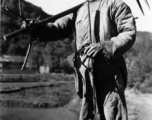 Local people in China: A Chinese farmer in Yunnan poses with a farming implement. During WWII.