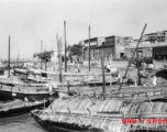 Boats at a mooring, and people, in India during WWII.